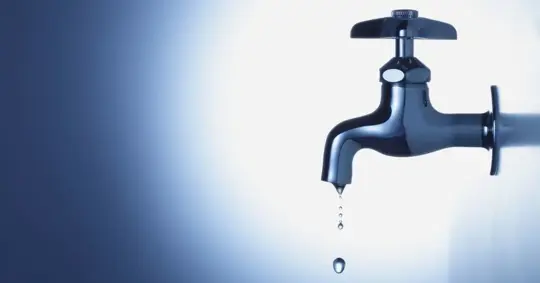 Shiny Chrome Faucet with Dripping Water